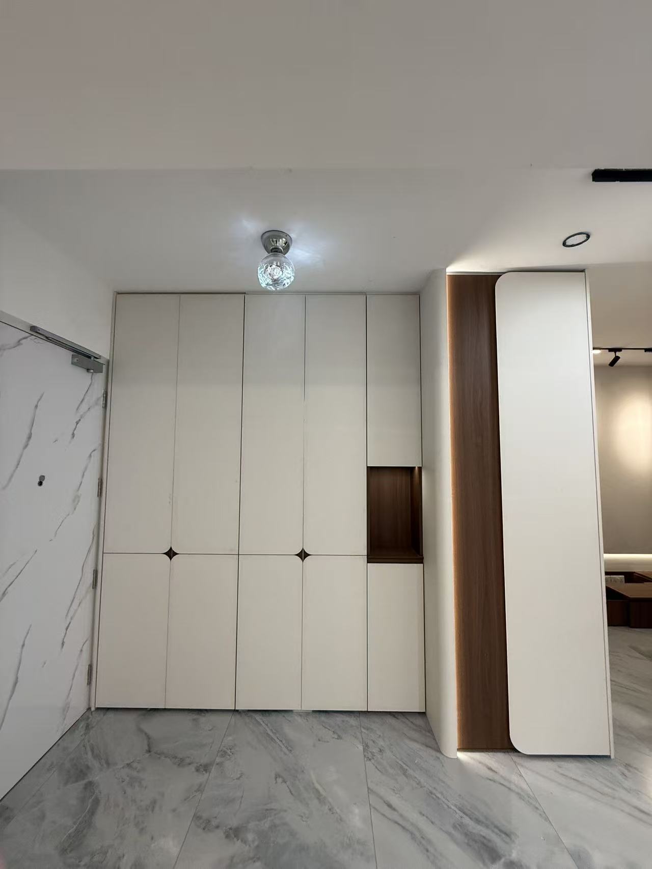 Bomb shelter concealment integrated into door-wall-cabinet system in Singapore HDB renovation by CASAWAVE